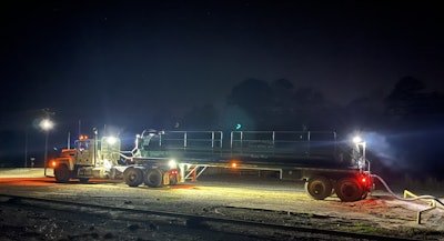John McGee Trucking truck at night on the jobsite