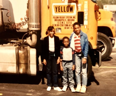 Omari Faulkner with his brother and sister standing next to their father's cabover
