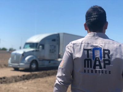 Tormap Services driver looking at his truck