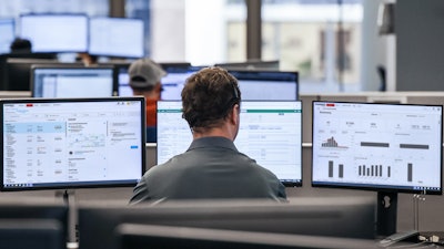 XPO employees at tri-monitor workstations