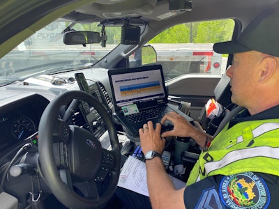 A Vermont Department of Motor Vehicles officer checks the ELD data from a driver.
