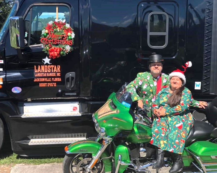 Bo Henry and his wife with their motorcycle and semi-truck