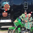 Bo Henry and his wife with their motorcycle and semi-truck