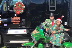 Bo Henry and his wife with their motorcycle and semi-truck