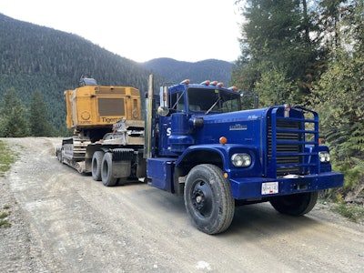 old blue hauls heavy machine