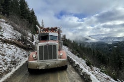 peterbilt log hauler on dirt road