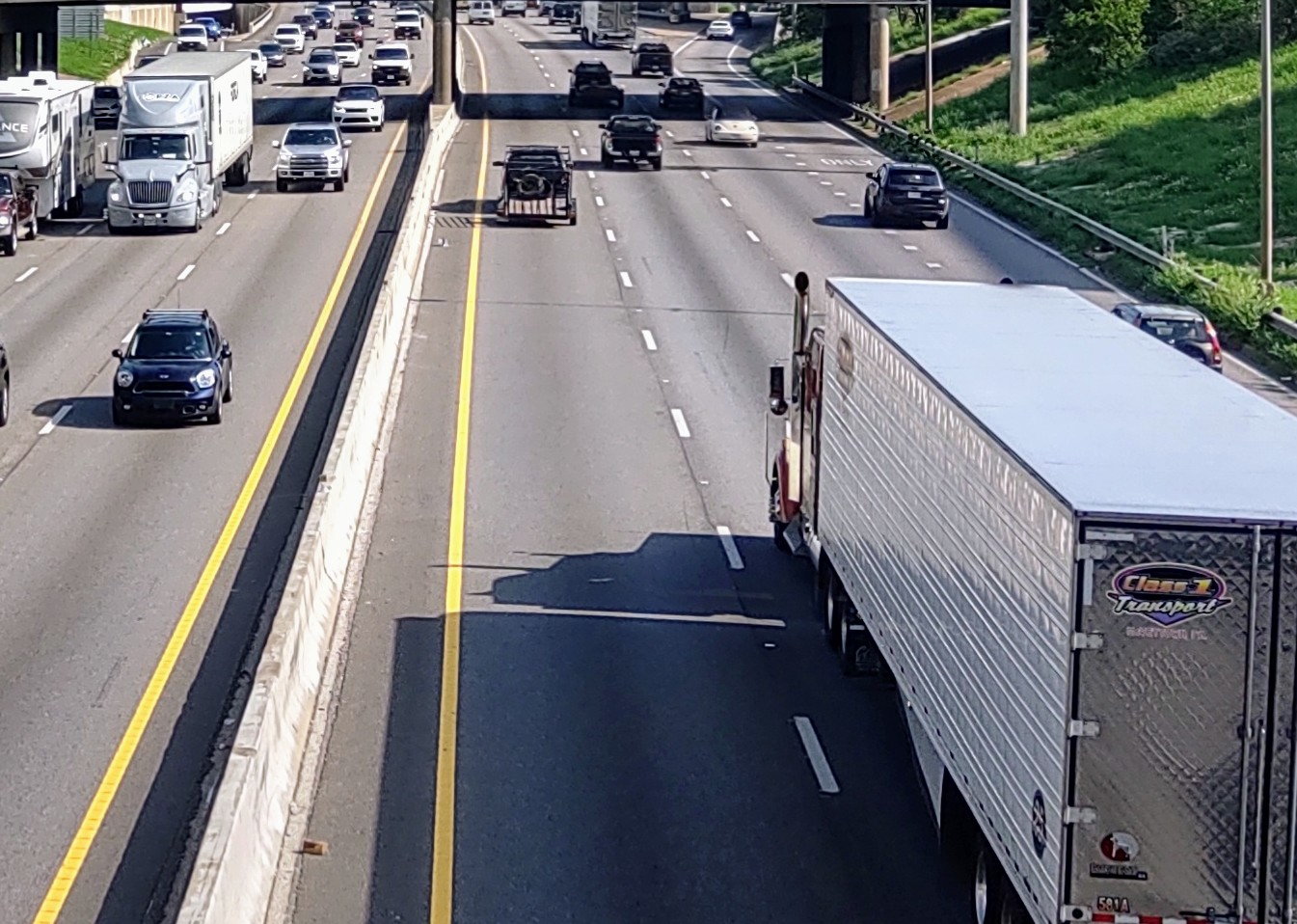 semi-trucks driving in traffic on highway
