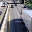 semi-trucks driving in traffic on highway