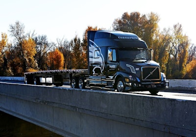 Cedarpoint Trucking semi-truck pulling a flatbed trailer across a bridge