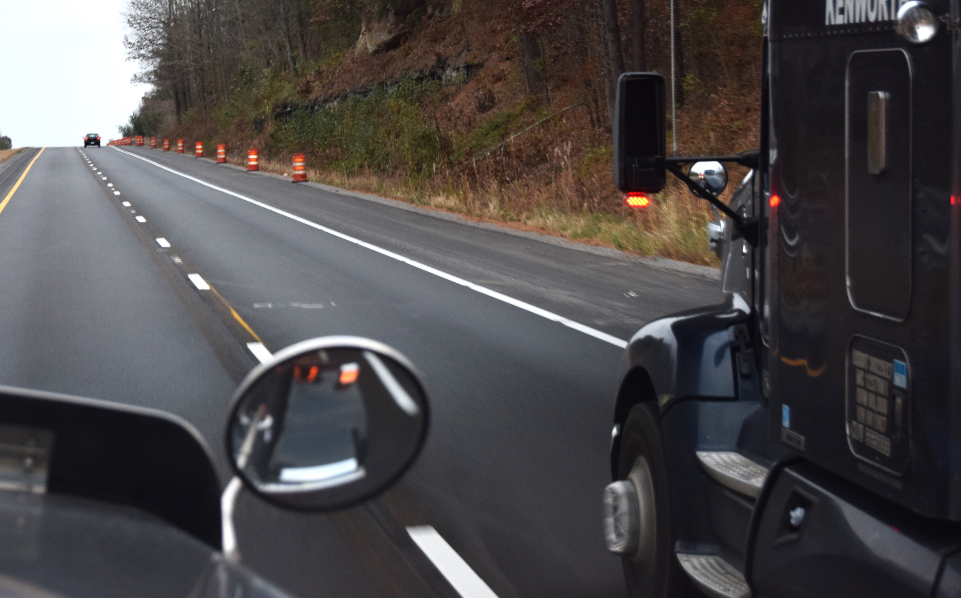 View of a highway from the windshield of a semi-truck