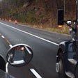 View of a highway from the windshield of a semi-truck