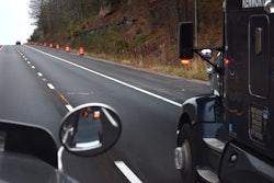 View of a highway from the windshield of a semi-truck