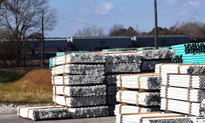 rail cars behind PVC pipe yard