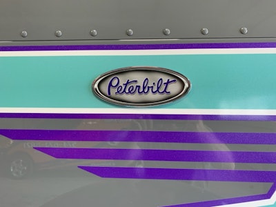For the colors on the very expensive piece of equipment, Terry took inspiration from an $8 shower curtain at home 'with two shades of gray and white, and a bit of aqua in it,' she said. The three-lower-stripe pattern shown here in detail on the hood is repeated near the back of the sleeper in mirror image, above the main stripe.