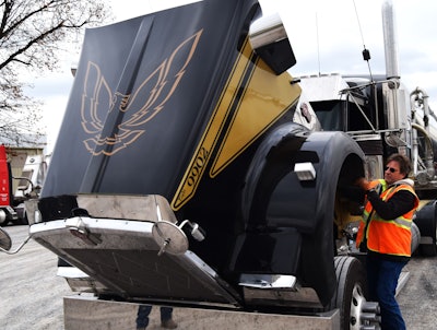 John McCormick raises Kenworth hood to reveal firebird graphic