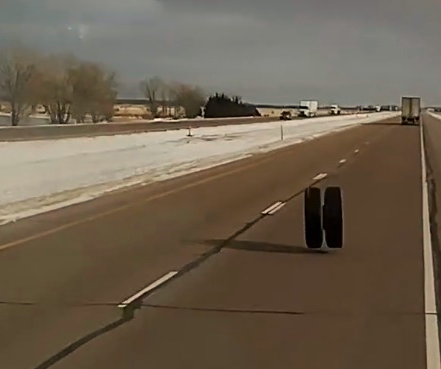 A separated tandem pair of wheels speeds toward impact with Long Haul Paul's truck