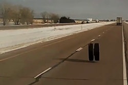 A separated tandem pair of wheels speeds toward impact with Long Haul Paul's truck