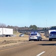 Semi-truck crash with police cars on a highway