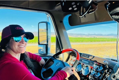 Tiffany Wallin sits behind the wheel of 2017 Freightliner Coronado glider.