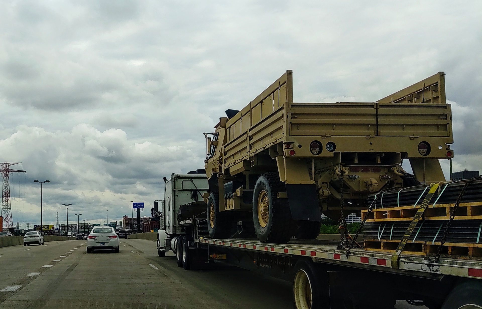 Military Vehicle On Flatbed Truck Highway