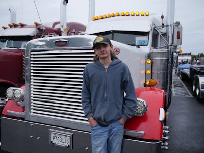 Tyler Hallman with his dad's 2000 Peterbilt 379