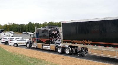 Rear view of John Highley's 2018 Kenworth W900L with Harley-Davidson motorcycle