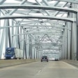 LTL semi-truck hauling doubles driving across a bridge