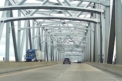 LTL semi-truck hauling doubles driving across a bridge