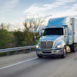 Blue International tractor on highway