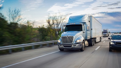 Blue International tractor on highway