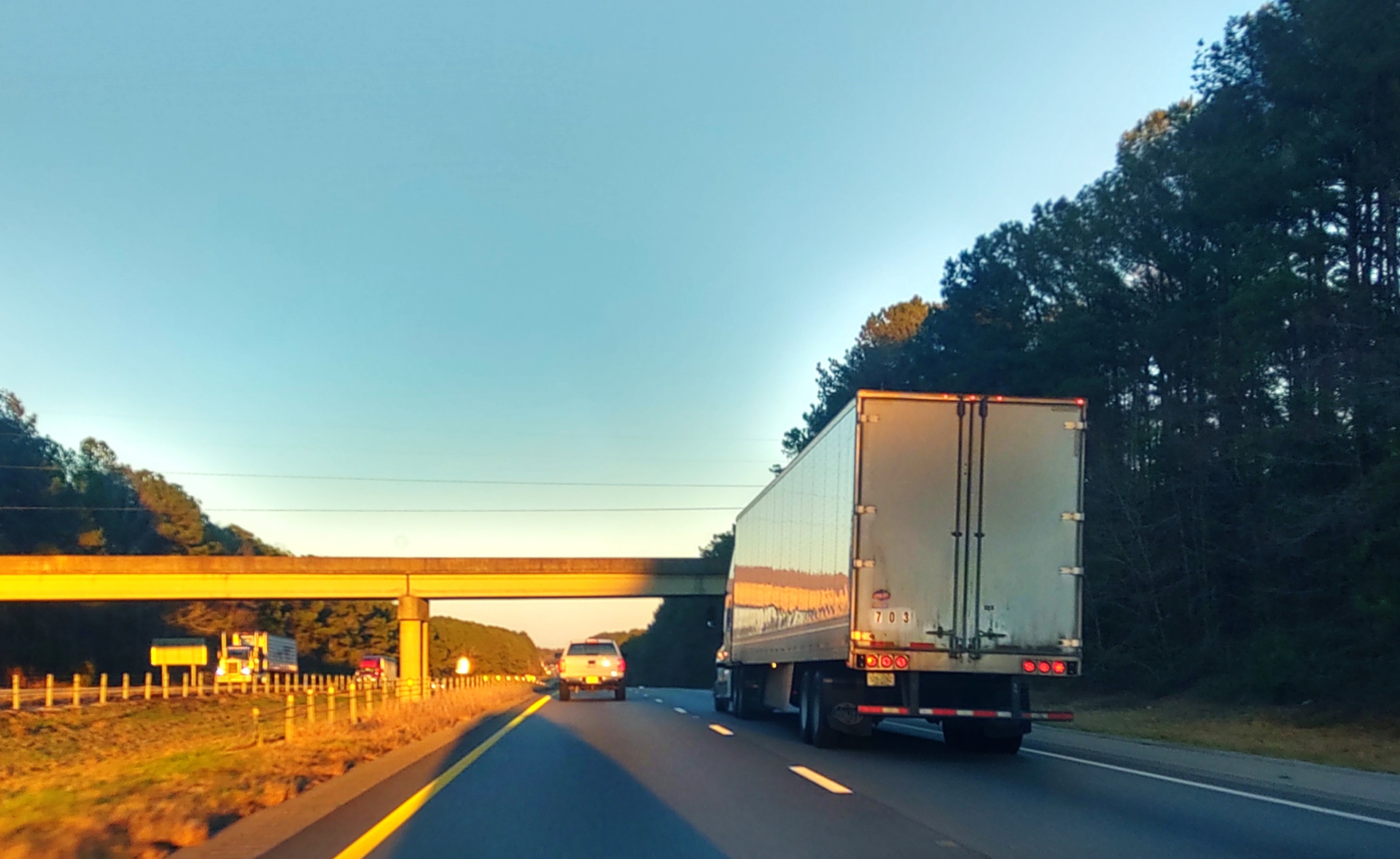 dry van truck on highway at sunset