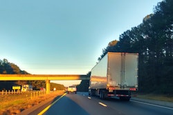 dry van truck on highway at sunset