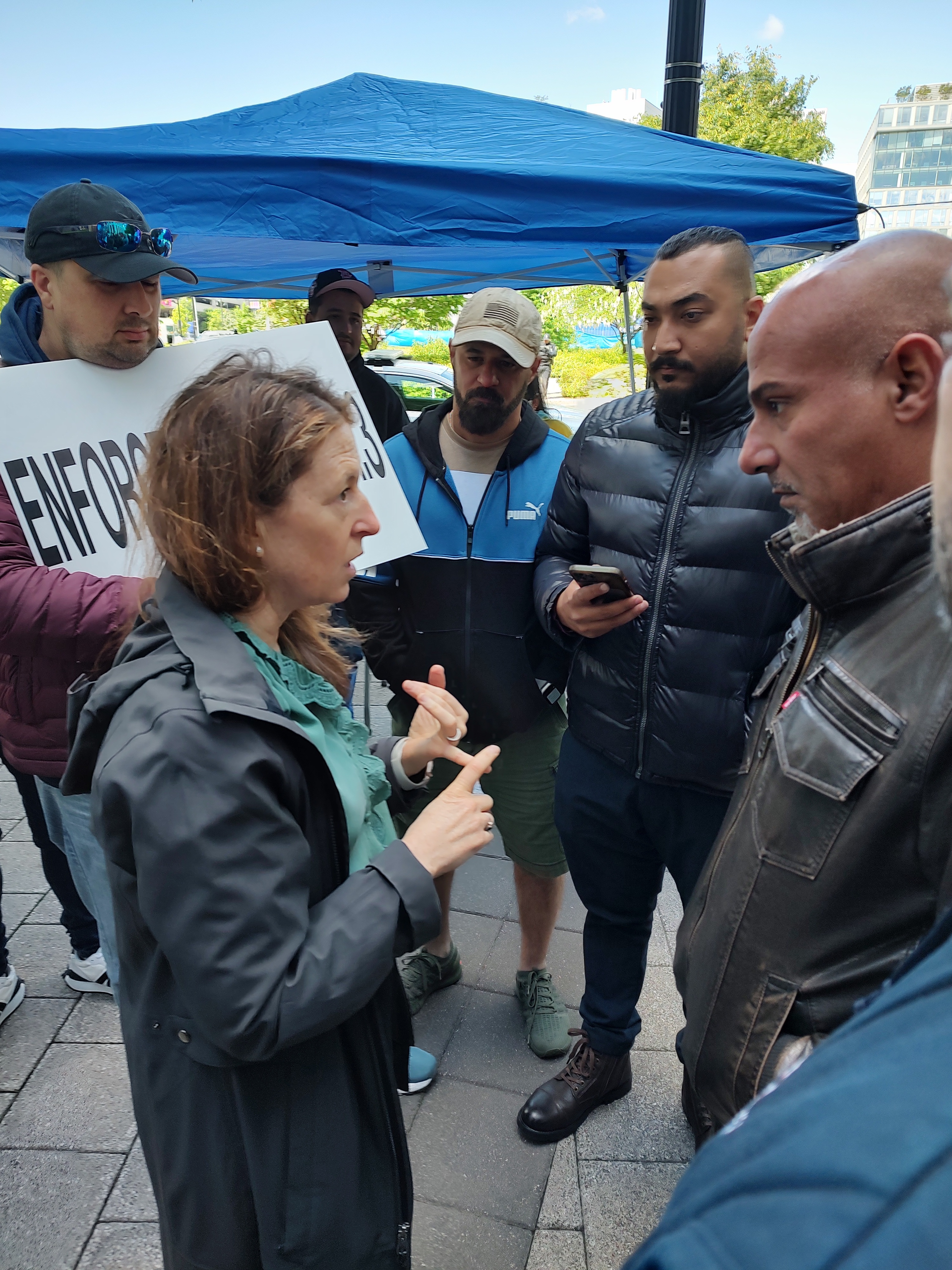FMCSA Administrator Robin Hutcheson with Truckers Movement for Justice demonstrators
