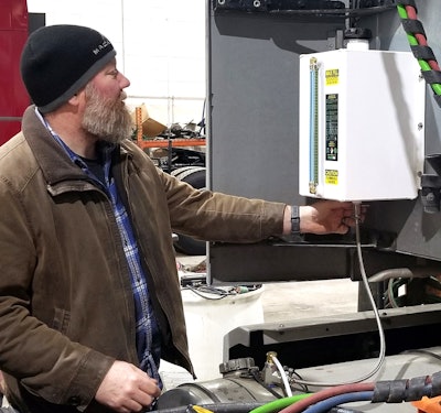 Jamie Hagen with the Clean Air Fleet doser on back of cab