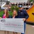 Pictured during a check presentation Thursday outside the Grand Ole Opry in Nashville, Tennessee (from right): Trucker-songwriter Tony Justice and his wife, Misty, with April Douglas of the Susan G. Komen Foundation