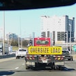 Oversize load sign on trailer, on highway