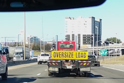Oversize load sign on trailer, on highway