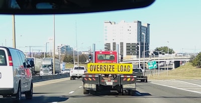 Oversize load sign on trailer, on highway
