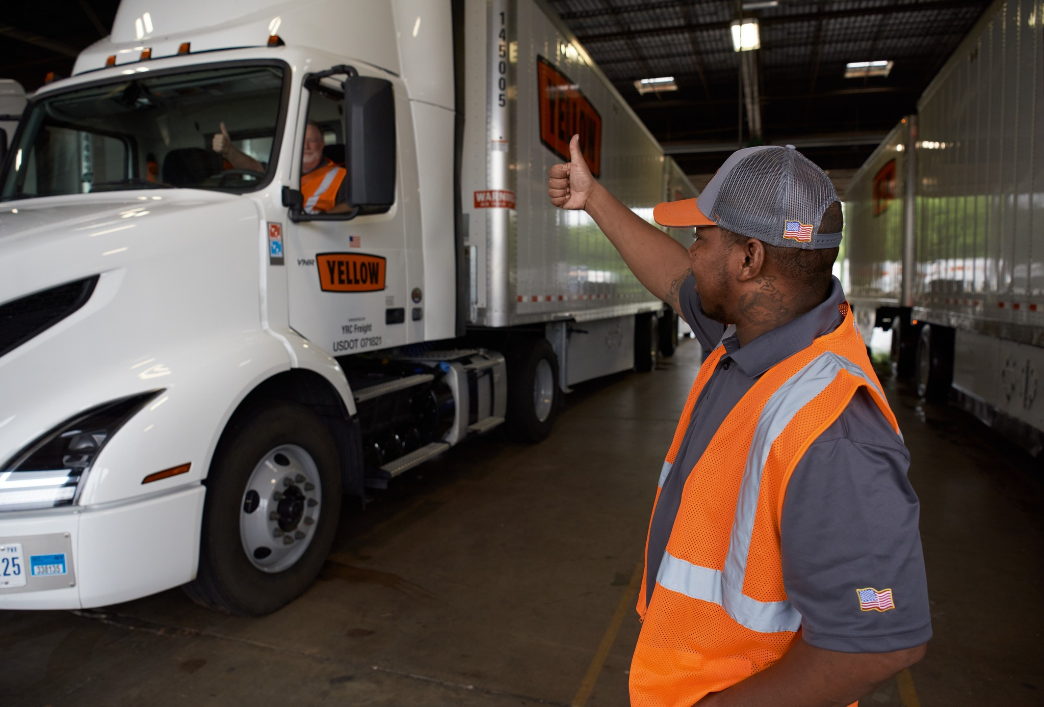 Yellow trucker giving a thumbs up