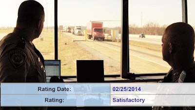 Inspectors watching trucks roll into a weigh station