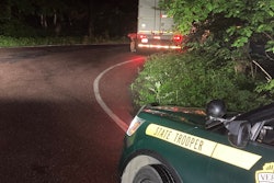 Vermont State Police vehicle parked behind the stuck semi-truck on smuggler's notch