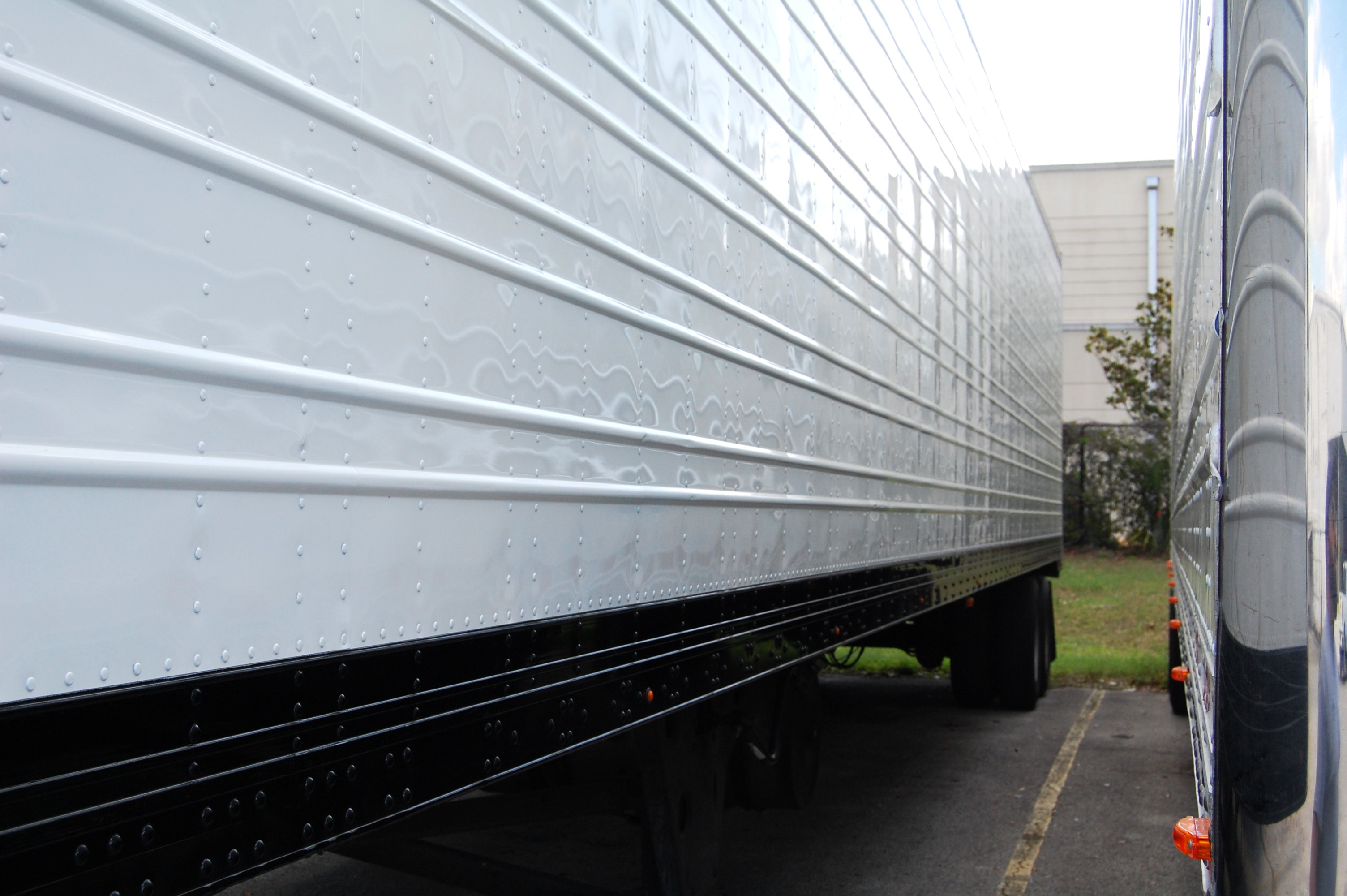 Two semi-truck trailers parked side by side