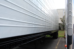 Two semi-truck trailers parked side by side
