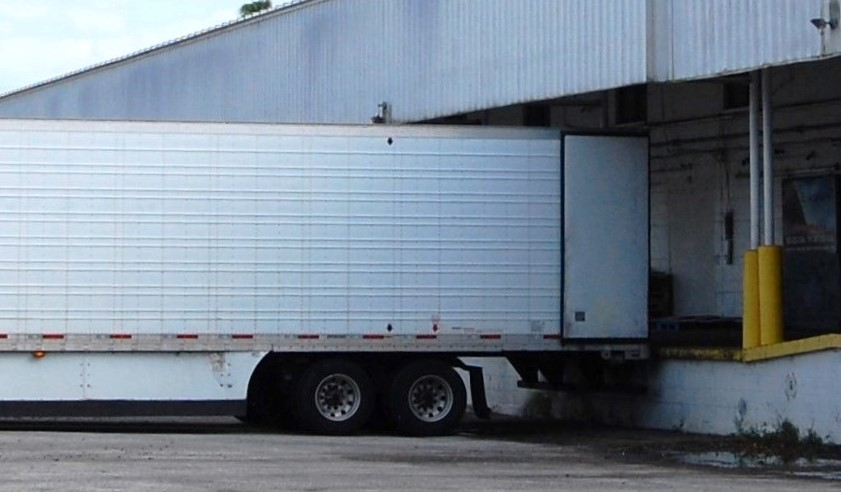 Semi-truck trailer parked at a loading dock