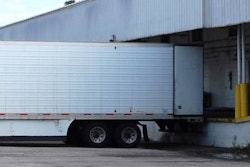 Semi-truck trailer parked at a loading dock