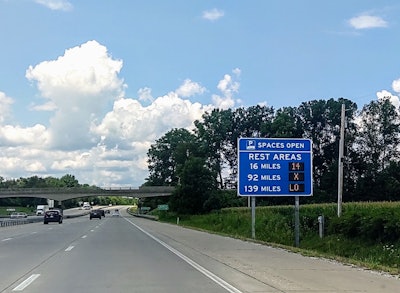 New source for rest-area parking availability info | The TruckParkingClub.com service -- pitched by founders as an 'AirBNB for truck parking' -- has added rest-area parking availability info from eight states to its service: Indiana, Iowa, Kansas, Kentucky, Minnesota, Michigan, Ohio, and Wisconsin. All of those states are places where availability info is tracked at public rest areas and shared via applications and in most cases roadside signs like the one in Indiana shown in the image here. Space availability info is now aggregated within the TruckParkingClub app and on its website, amounting to a network of 143 rest stops across the eight states, in addition to other pay-and-reserve locations already listed in the app. Read more about TruckParkingClub.com in the story at this link from earlier in the year.