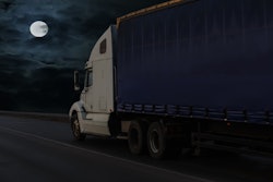 semi truck on highway with moon