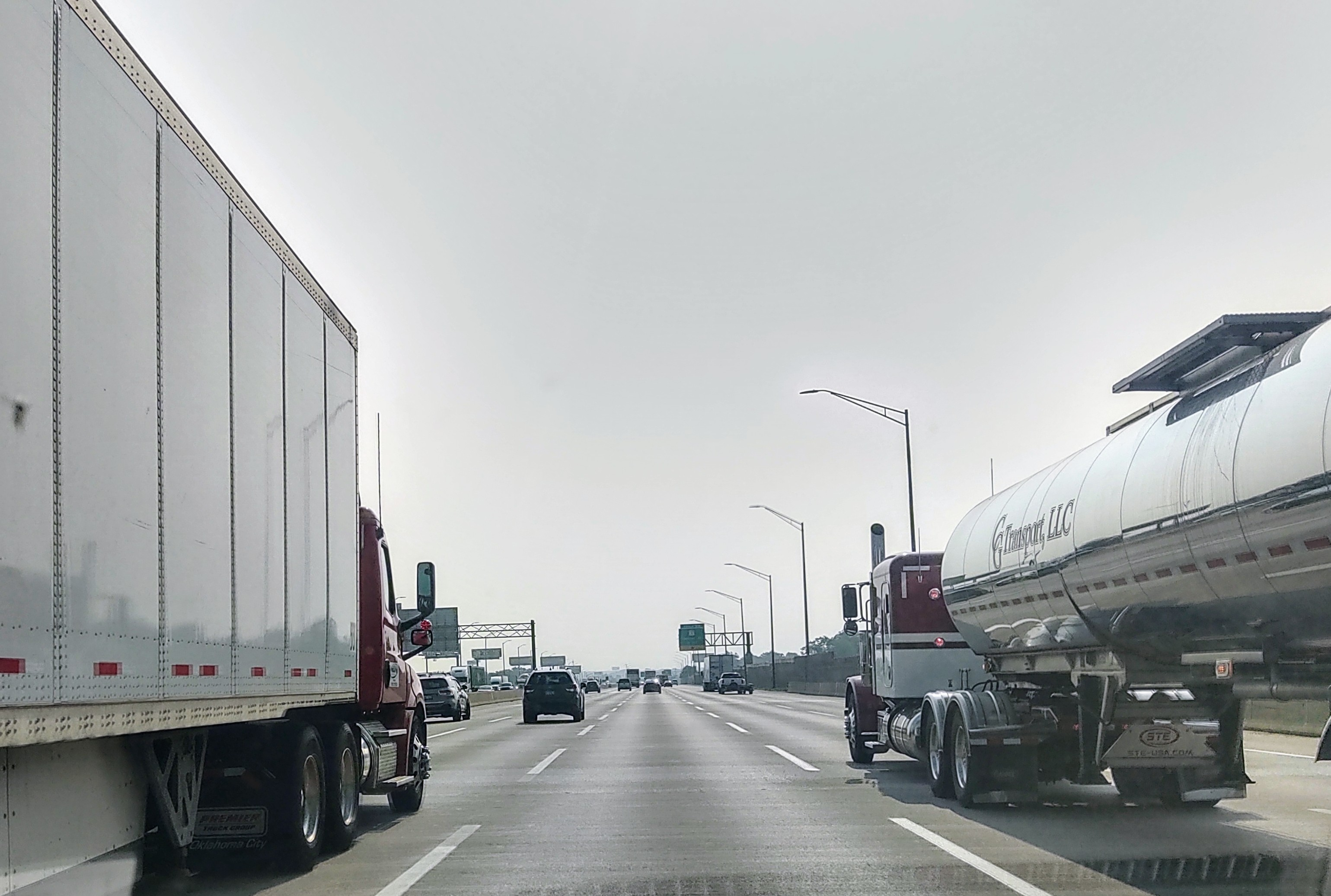 Van and tanker trucks on highway