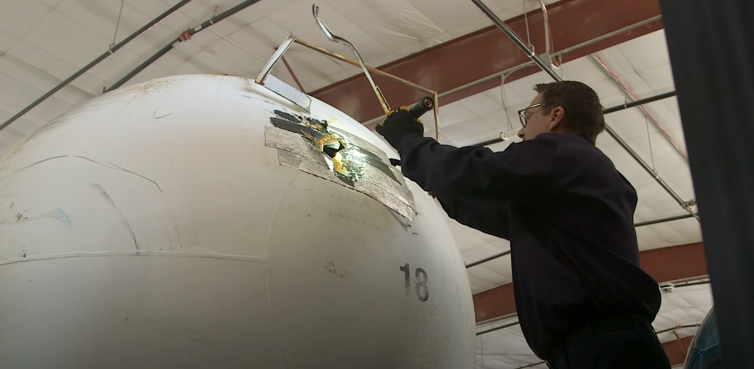 NTSB investigator inspecting anhydrous ammonia tanker