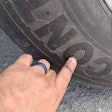 David Lucas showing tire punctures on his truck